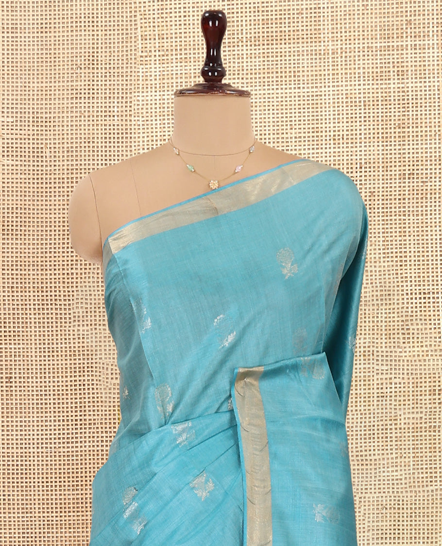 Blue Tussar Saree, Bedecked with Buttas, a Subtle Zari Border, Pallu of Intricate Designs, and a Matching Blouse