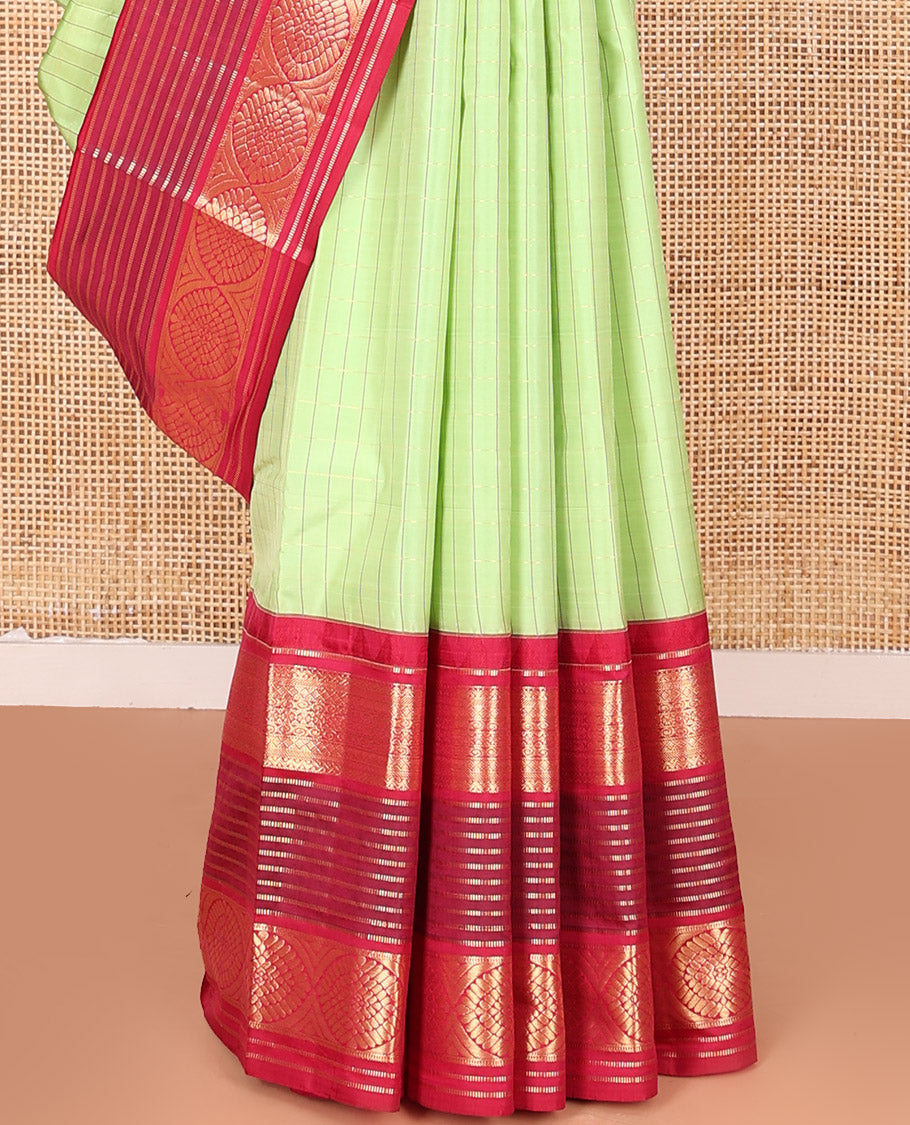 Green Vasundhara Silk Saree Subtly Sparkled with Stripes, Highlighted by a Contrast Border of Muthu, Diamond, Kamalam, and Laddu Kamalam Designs, Delicately Woven Pallu of Intricate Designs, and Paired with a Contrast Blouse