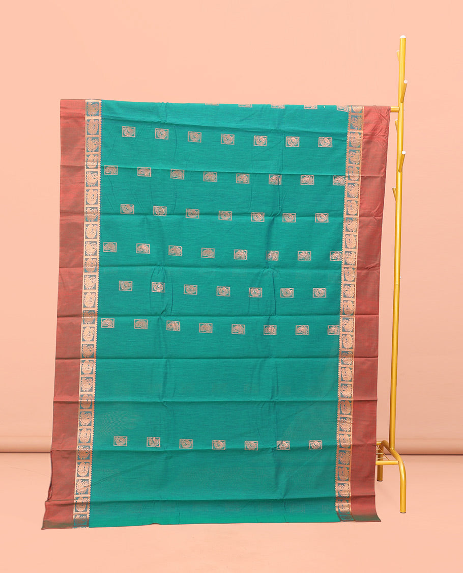 Green Semi-Silk Cotton Saree, Impeccably Styled with Buttas All Over Its Body, Complemented by a Contrast Peacock Design Kal Eragina Border, Pallu Steeped with Elephant Design, and Paired with a Matching Blouse
