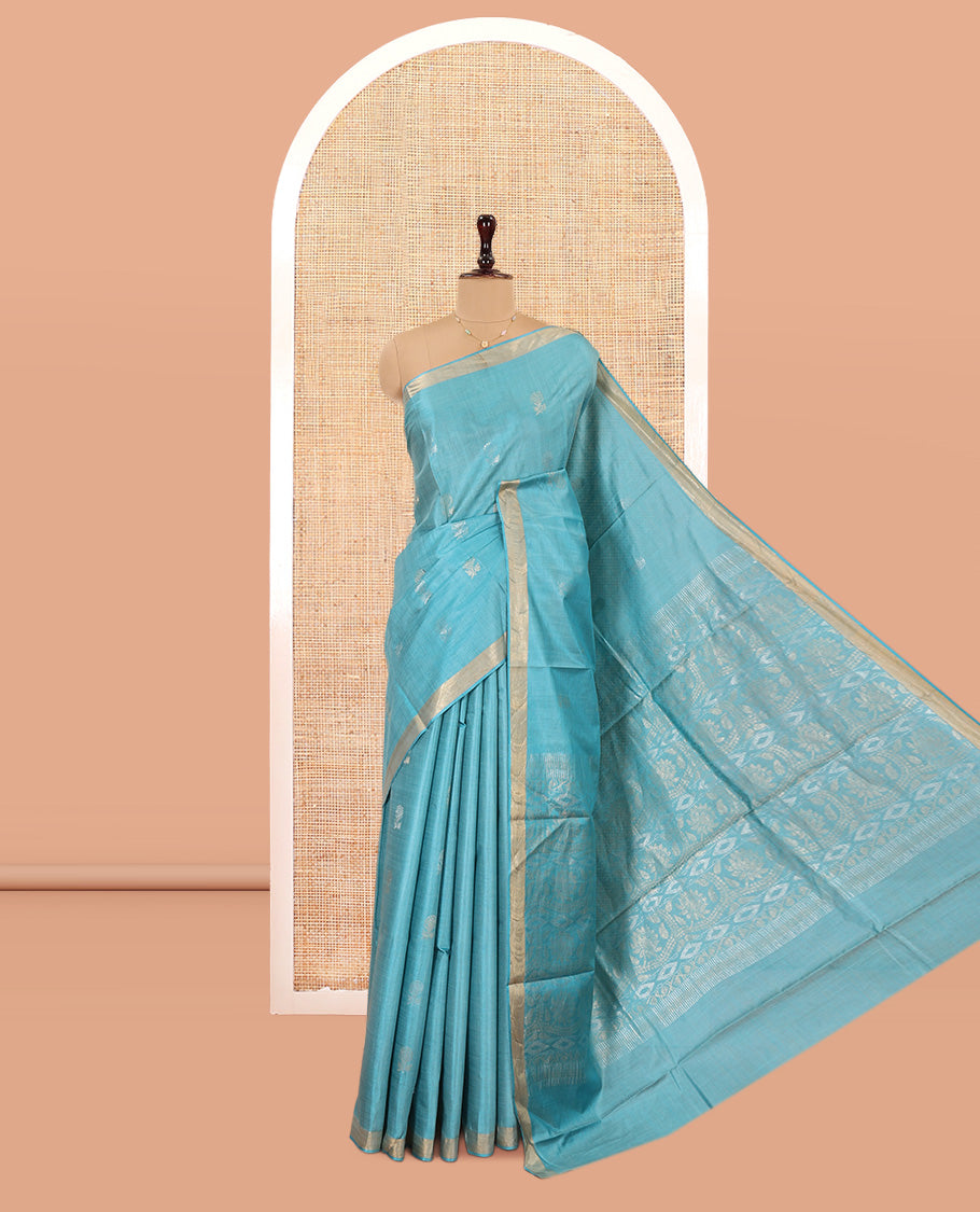 Blue Tussar Saree, Bedecked with Buttas, a Subtle Zari Border, Pallu of Intricate Designs, and a Matching Blouse