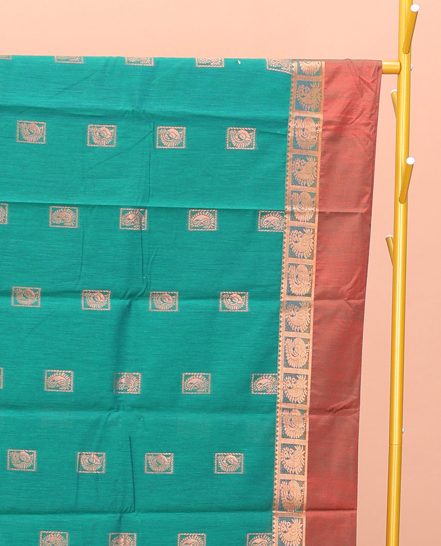 Green Semi-Silk Cotton Saree, Impeccably Styled with Buttas All Over Its Body, Complemented by a Contrast Peacock Design Kal Eragina Border, Pallu Steeped with Elephant Design, and Paired with a Matching Blouse