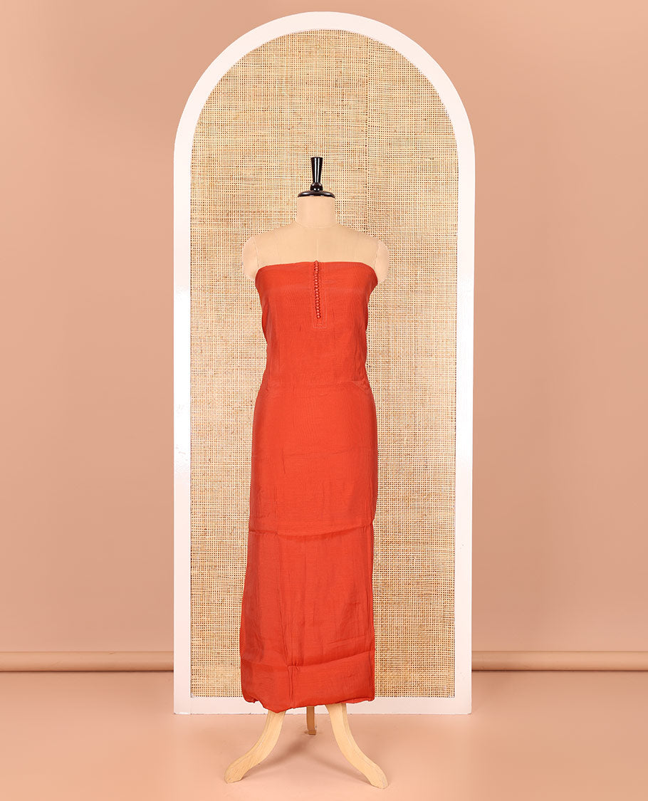 Rust material chudidar set, plain with pom-pom tasseled mul chanderi top, a matching bottom, and organza dupatta of stripes