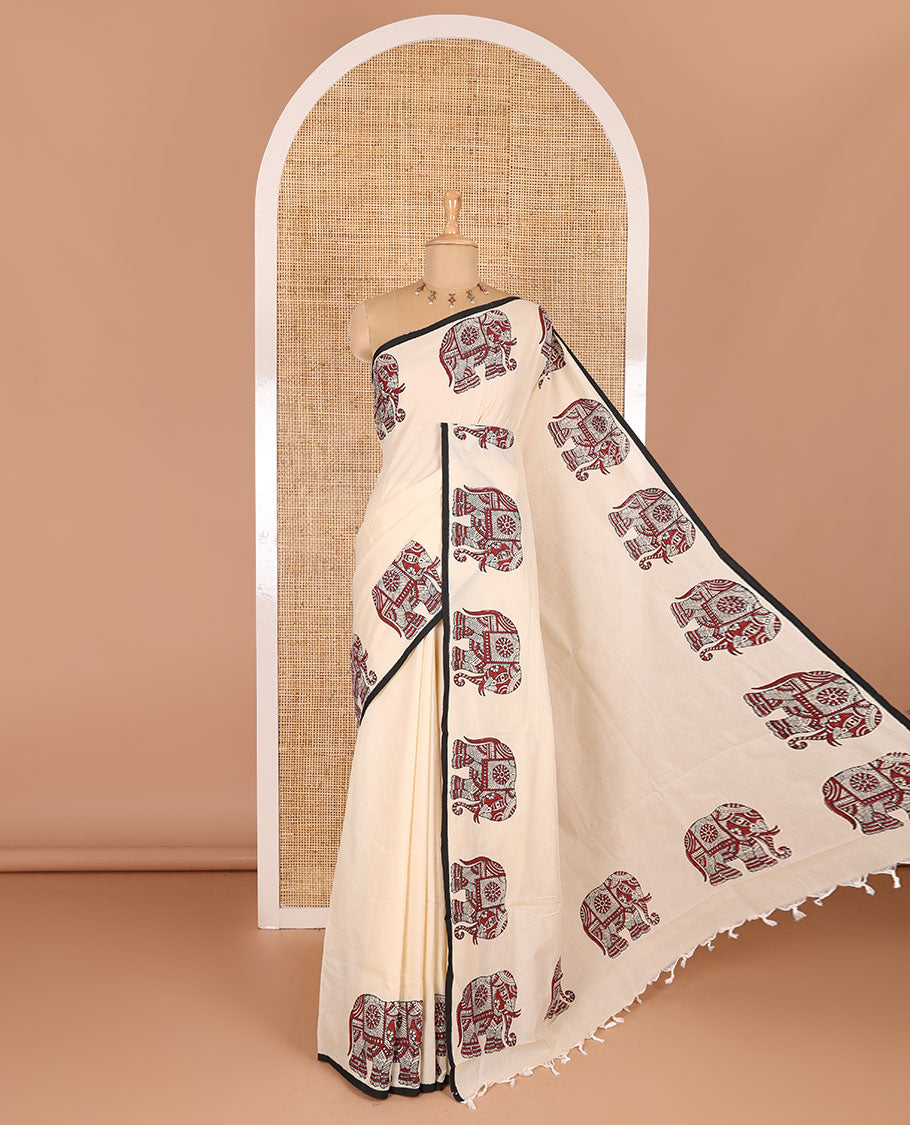 Cream plain South cotton saree with double-sided block printed borders of elephant motifs, and a matching printed blouse