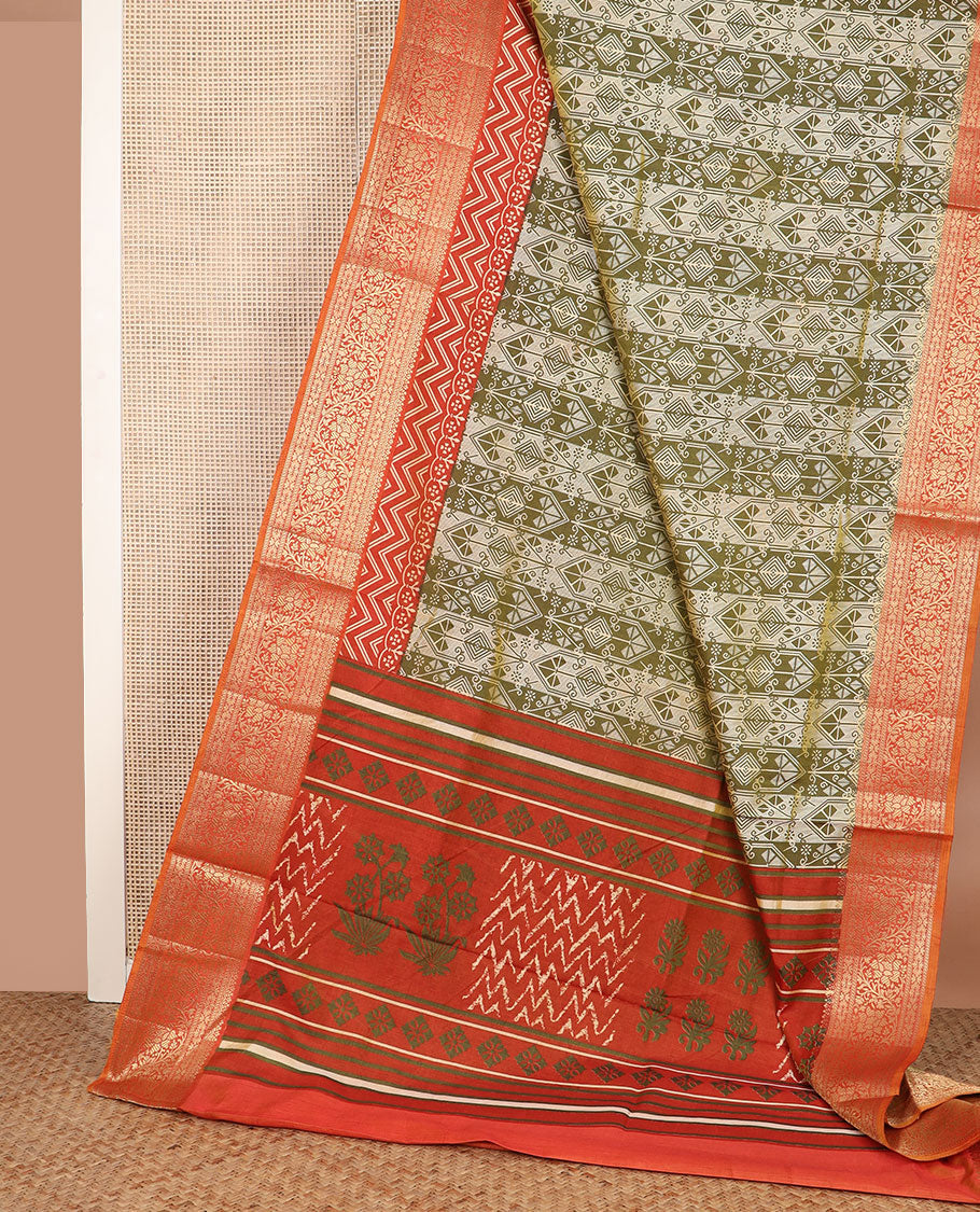 Olive green intricately designed semi-banaras patola silk saree, contrast floral creeper zari design border, and pallu of chevron and floral designs