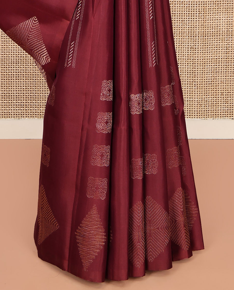 Borderless Maroon Mayuri Soft Silk Saree, Adorned with Buttas All Over Its Body, a Self-Pallu of Geometric Patterns, and Paired with a Matching Blouse