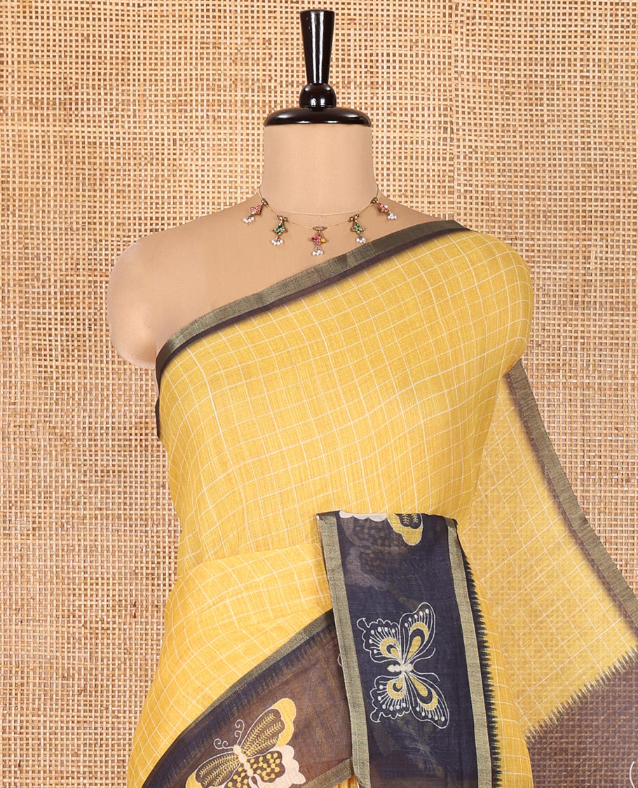 Yellow Linen Cotton Saree, Subtly Sparkled With Checked Design On Its Body, Complemented by Contrast Border Artfully Printed with Butterflies, Pallu Steeped with Butterflies, and Paired with a Contrast Blouse