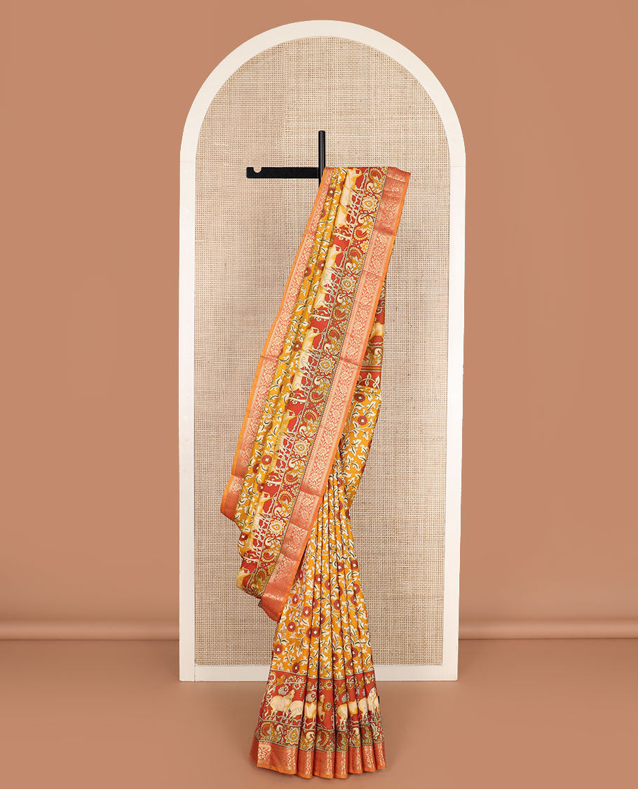 Orange floral vine patola silk saree, contrast traditional zari border and pallu of Pichwai cow and peacock motifs