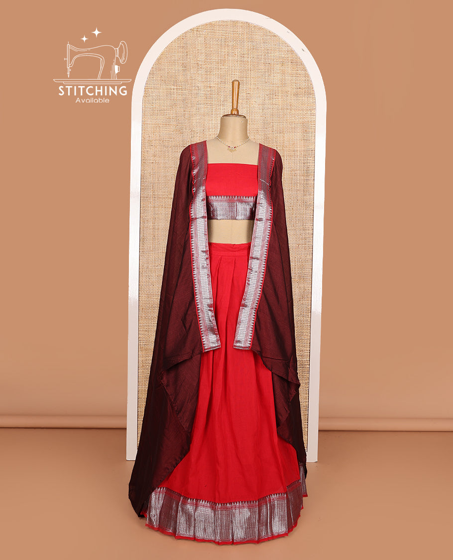 Red cotton half-saree, plain with contrast geometric bordered skirt, matching blouse, and contrast geometric bordered dhavani