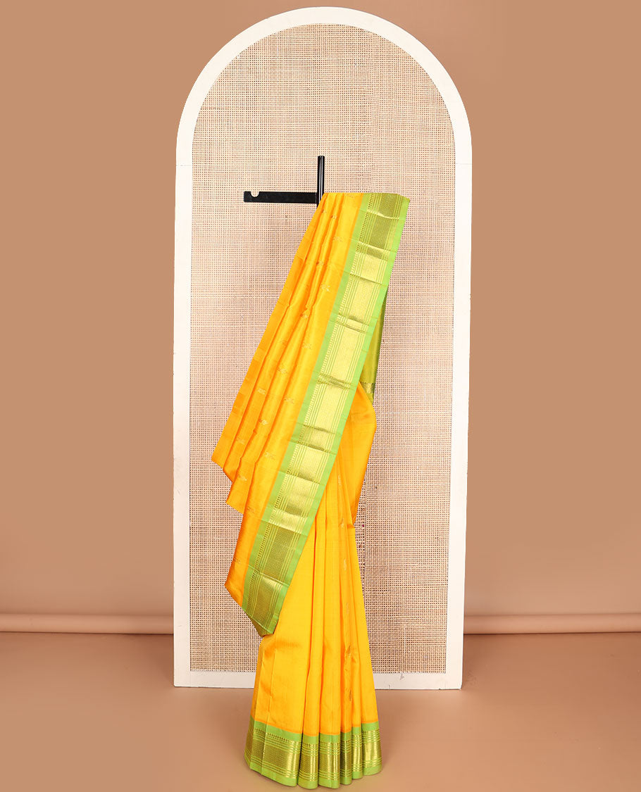 Yellow zari buttas Kanchipuram silksaree, contrast one-sided border of panner sombu,muthu & mayil kann & zari design pallu