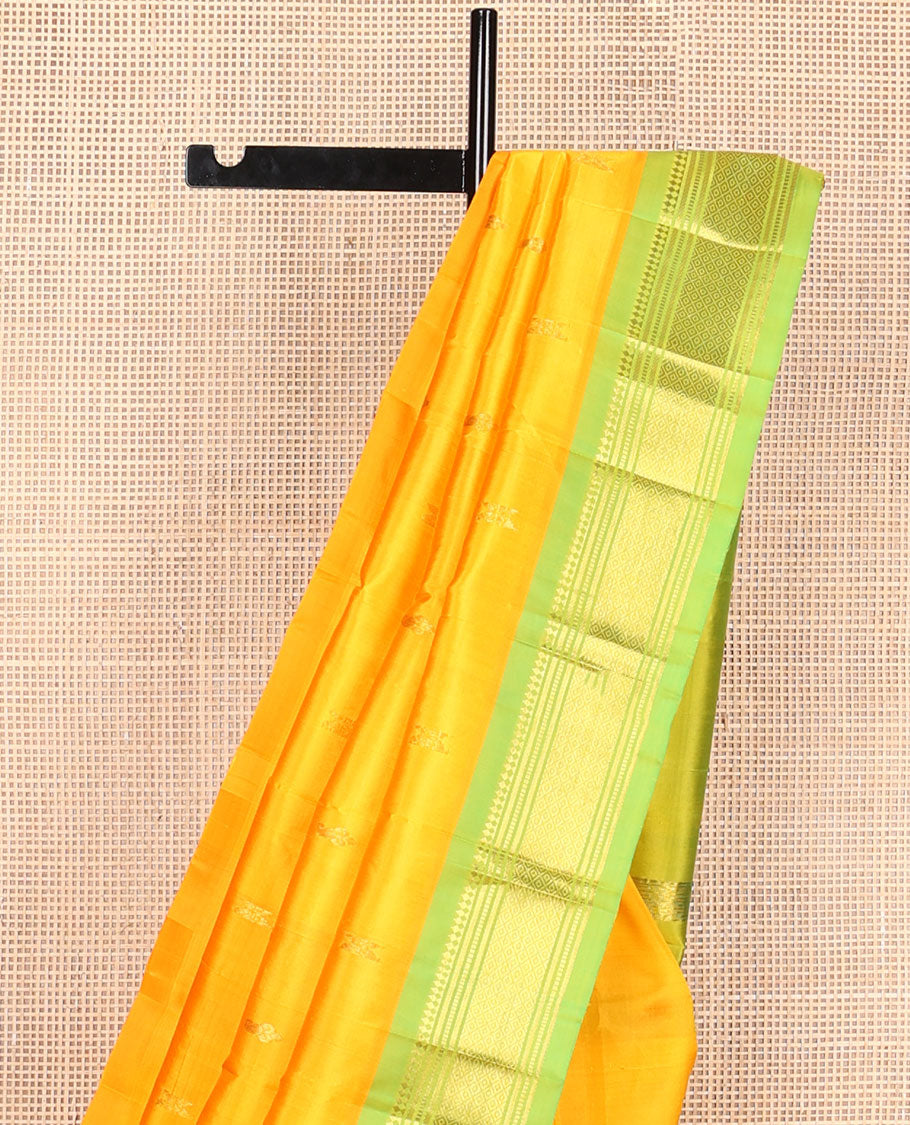 Yellow zari buttas Kanchipuram silksaree, contrast one-sided border of panner sombu,muthu & mayil kann & zari design pallu