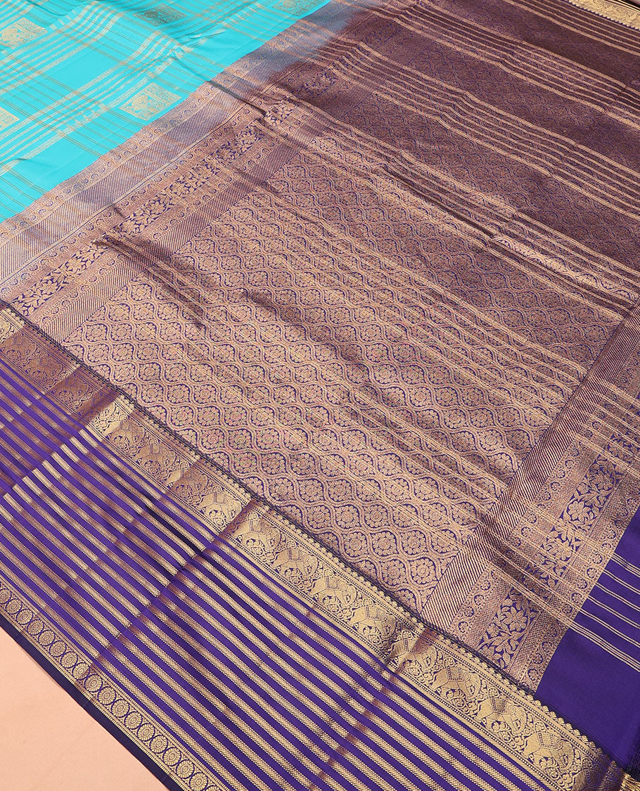 Blue zari buttas and checked Vasundhara silk mix saree, contrast varisai pettu border of salangai, yaanai, muthu, kathir, and chakram designs, and ogee patterned pallu