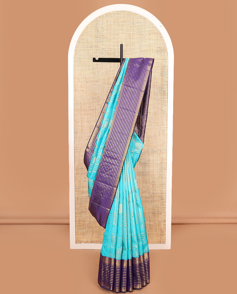 Blue zari buttas and checked Vasundhara silk mix saree, contrast varisai pettu border of salangai, yaanai, muthu, kathir, and chakram designs, and ogee patterned pallu