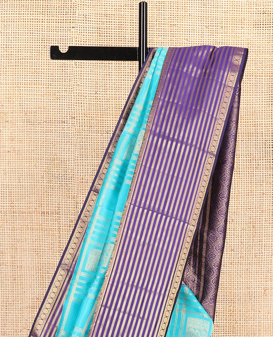 Blue zari buttas and checked Vasundhara silk mix saree, contrast varisai pettu border of salangai, yaanai, muthu, kathir, and chakram designs, and ogee patterned pallu