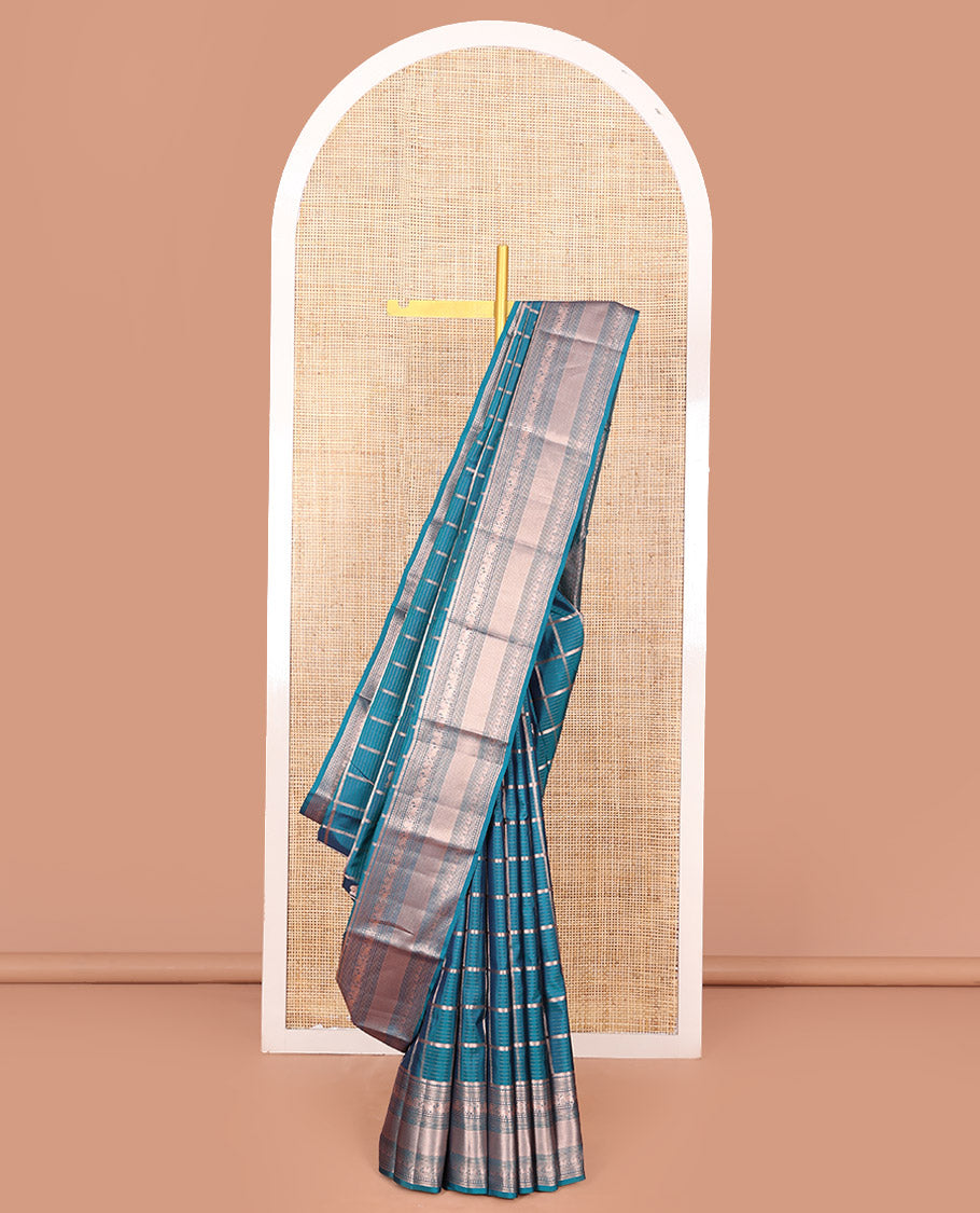 Blue Vasundhara Silk Saree Beautifully Bedecked with Medium Zari Checks, Highlighted by a Zari Border of Salngai, Mayil, Yaanai, Muthu, and Mayil Kann Designs, Delicately Woven Pallu, and Paired with a Matching Blouse