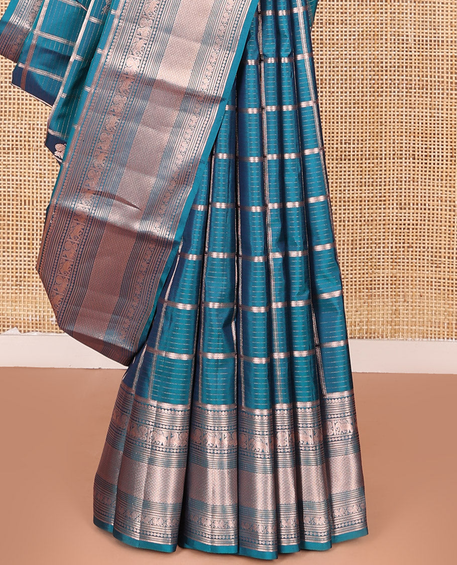 Blue Vasundhara Silk Saree Beautifully Bedecked with Medium Zari Checks, Highlighted by a Zari Border of Salngai, Mayil, Yaanai, Muthu, and Mayil Kann Designs, Delicately Woven Pallu, and Paired with a Matching Blouse