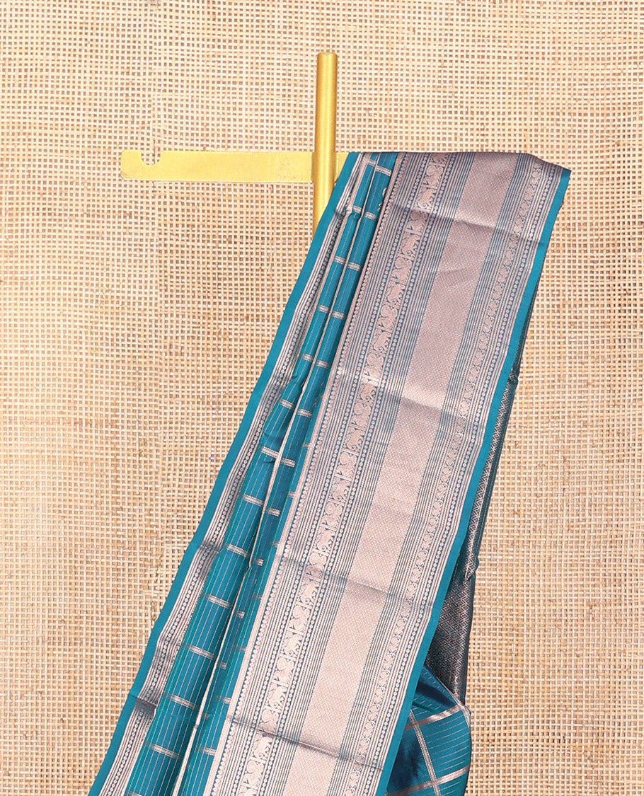 Blue Vasundhara Silk Saree Beautifully Bedecked with Medium Zari Checks, Highlighted by a Zari Border of Salngai, Mayil, Yaanai, Muthu, and Mayil Kann Designs, Delicately Woven Pallu, and Paired with a Matching Blouse