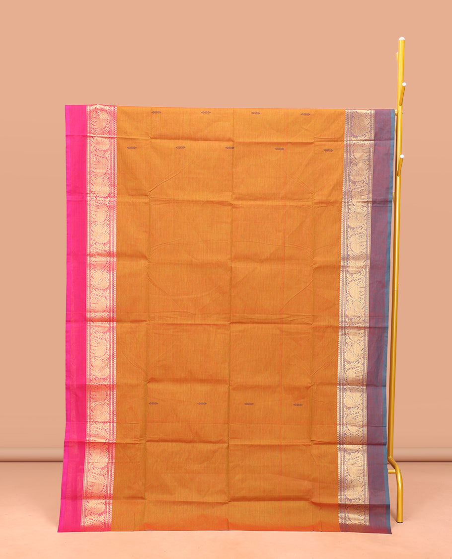 Orange Chettinad Cotton Saree, Finely Crafted with Buttas All Over Its Body, Complemented by a Contrast Ganga-Jamuna Kal Eragina Border of Kodi Peacock and Elephant Designs, Pallu of Buttas and Stripes, and Paired with a Matching Blouse