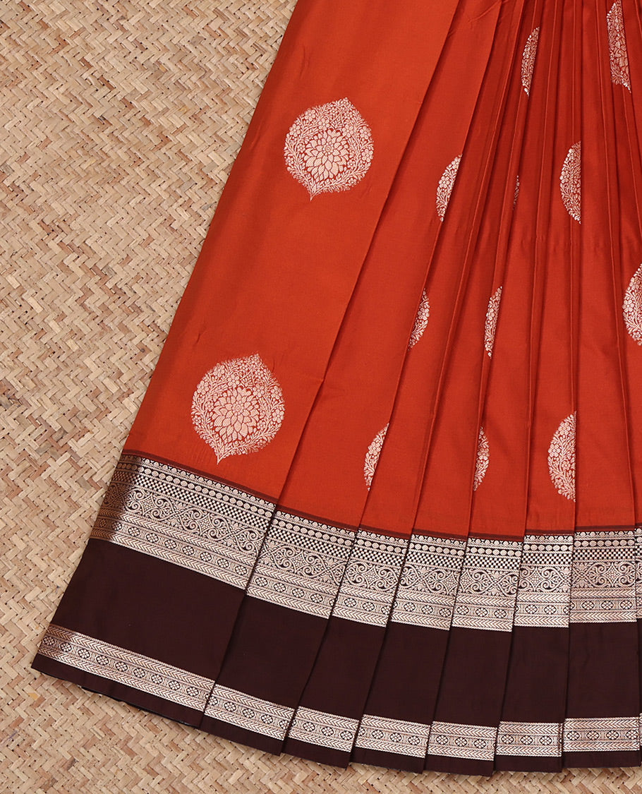 Rust Orange Budget Silk Saree, Gleamed Up with Zari Buttas All Over Its Body, Complemented by a Contrast Traditional Zari Design Rettai Pettu Border, Grand Pallu, and Paired with a Contrast Blouse