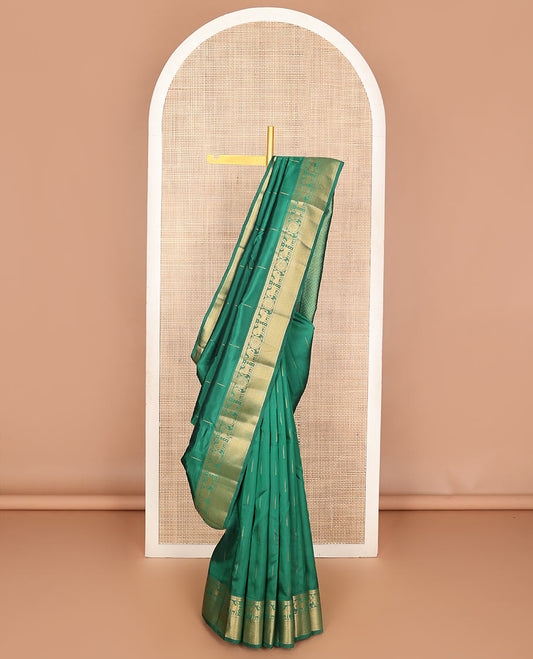 Dark Green malli mokku zari buttas Vasundhara silk mix saree, zari border of rekku, rudraksham, yaali , chakram & mayil kann & intricate pallu