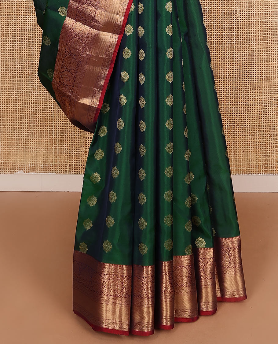 Green zari buttas Vasundhara silk mix saree, contrast border of thilakam, laddu kamalam, muthu, and kathir designs, and pallu of floral designs
