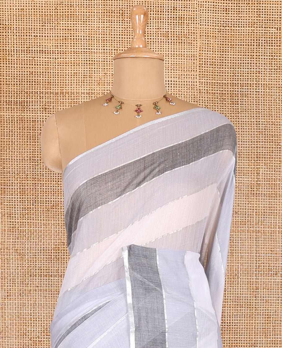 Grey ombre-colored striped khadi mul cotton saree, zari piping border, striped pallu, and a matching striped blouse