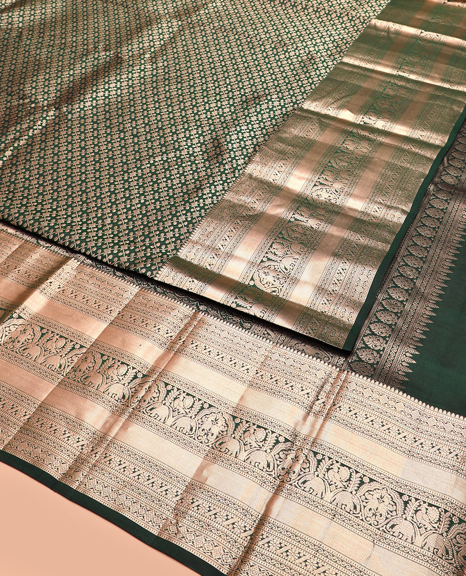 Green Kanchipuram Silk Saree Spotlighted with Jacquard Design, Highlighted by Zari Border of Thilakam, Diamond, Chakram, Cross Kamalam, Mayil, Yaanai, and Zari Designs, Pallu Pictures Big Yaali Designs, and Paired with a Matching Blouse