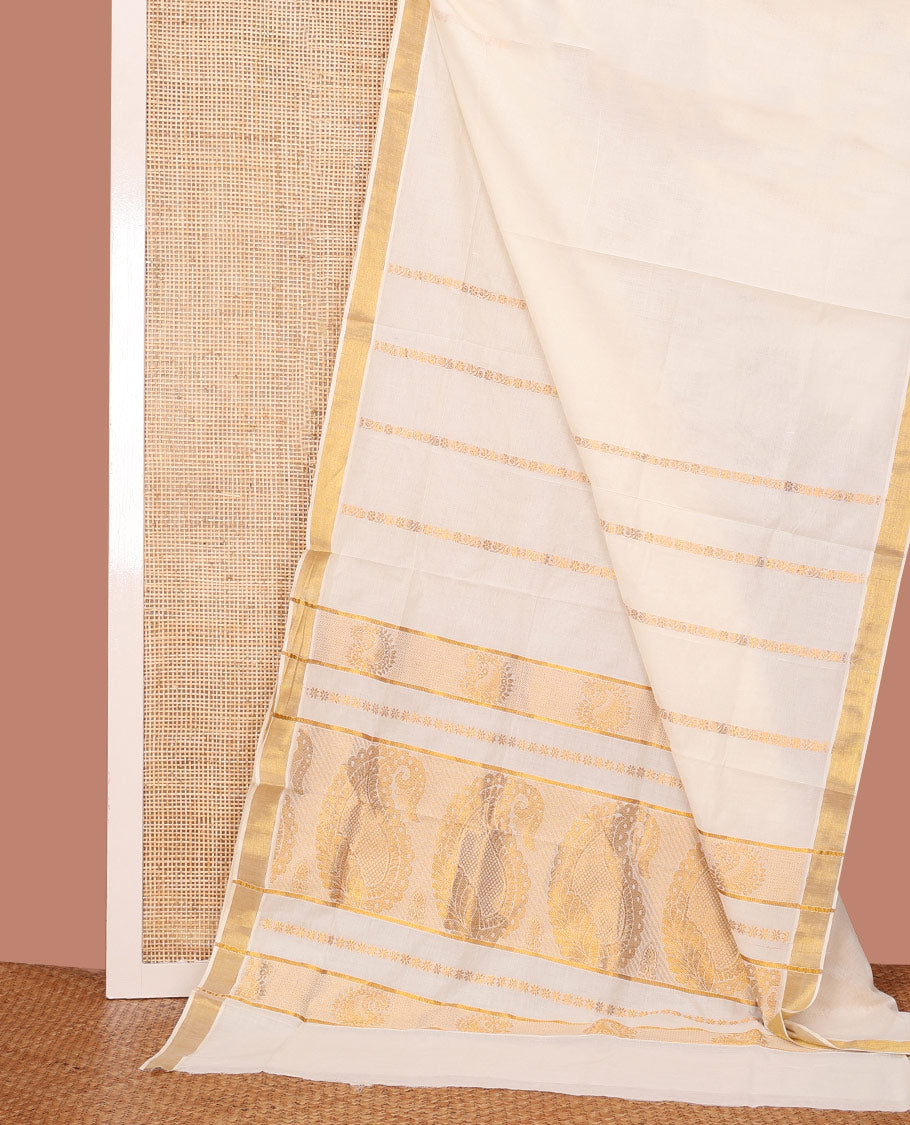 Cream Kerala Cotton Saree Adorned with Zari Stripes All Over Its Body, Zari Bavanji Border, Pallu Features Peacock and Paisley Designs, and Paired with a Matching Blouse