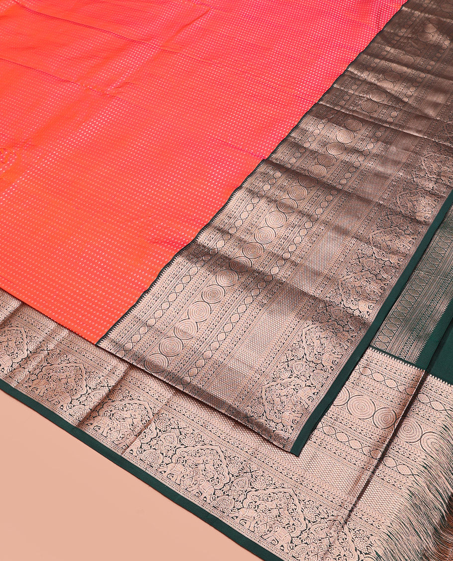 Orange Vasundhara Silk Saree Gracefully Embellished with Dobby-Style Zari Buttas, Highlighted by a Contrast Border of Rekku, Kathir, Cross Kamalam, Chakram, Mayil Kann, Mayil, and Yaanai, Scintillating Jaal Pallu, and Paired with a Contrast Blouse
