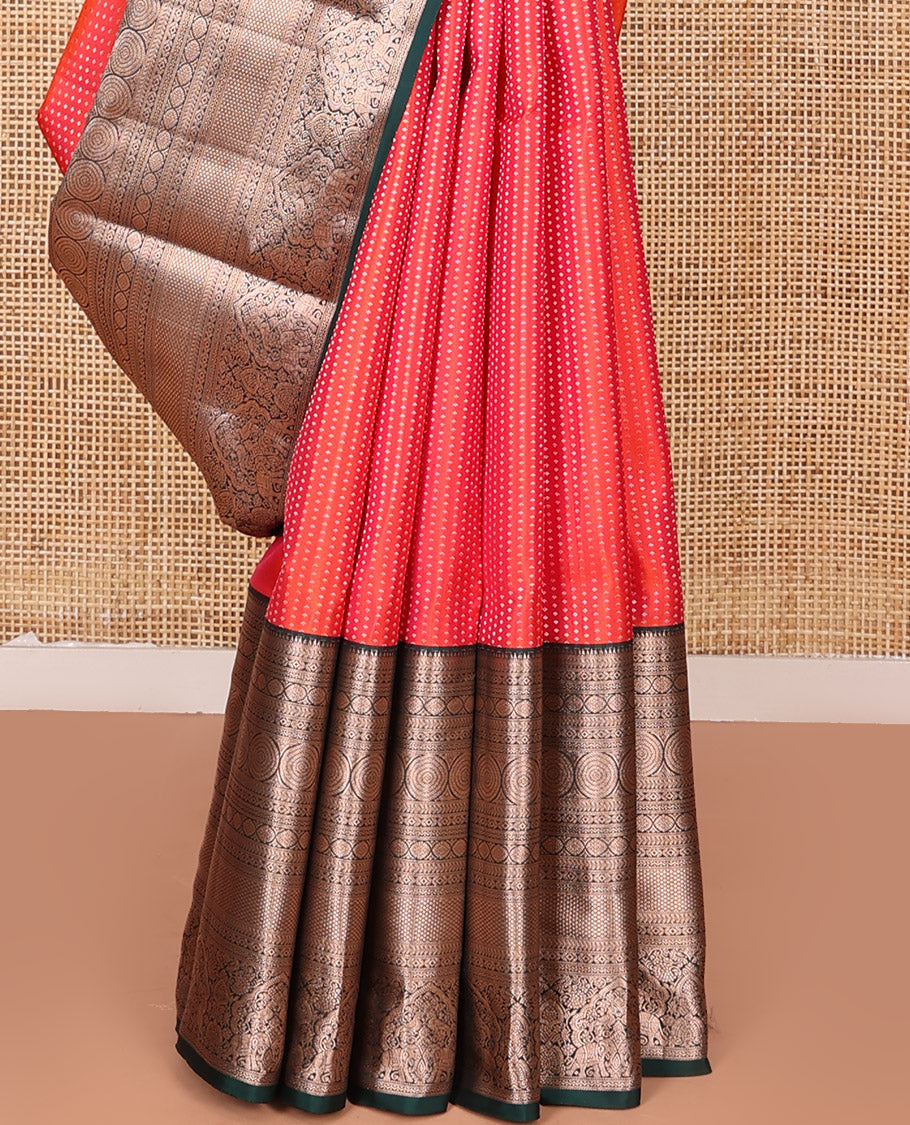 Orange Vasundhara Silk Saree Gracefully Embellished with Dobby-Style Zari Buttas, Highlighted by a Contrast Border of Rekku, Kathir, Cross Kamalam, Chakram, Mayil Kann, Mayil, and Yaanai, Scintillating Jaal Pallu, and Paired with a Contrast Blouse