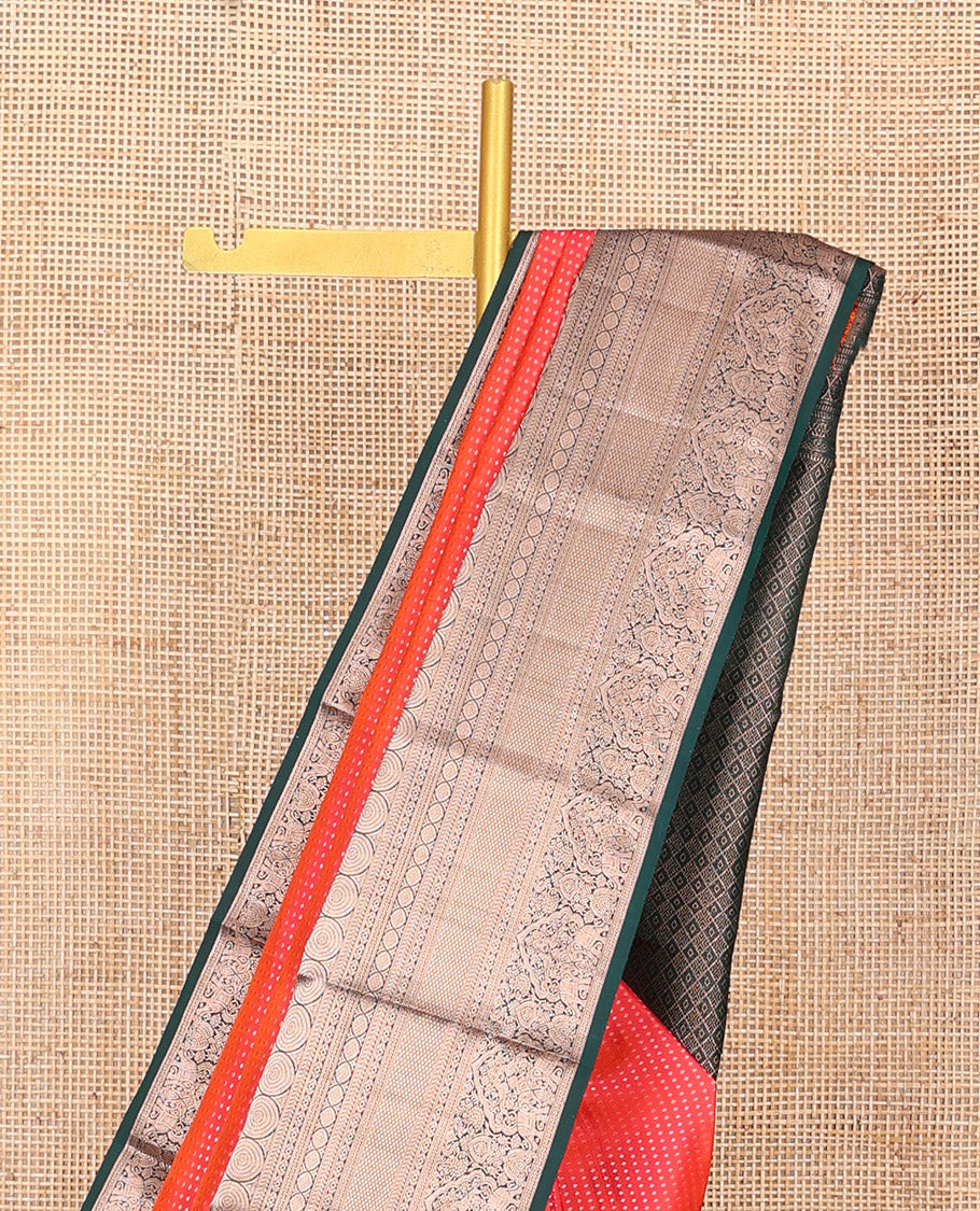 Orange Vasundhara Silk Saree Gracefully Embellished with Dobby-Style Zari Buttas, Highlighted by a Contrast Border of Rekku, Kathir, Cross Kamalam, Chakram, Mayil Kann, Mayil, and Yaanai, Scintillating Jaal Pallu, and Paired with a Contrast Blouse