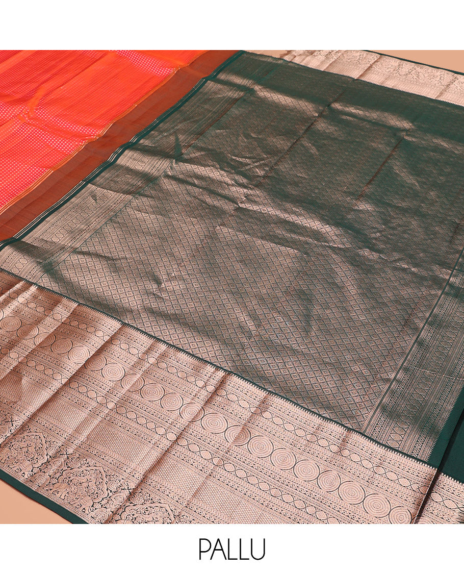 Orange Vasundhara Silk Saree Gracefully Embellished with Dobby-Style Zari Buttas, Highlighted by a Contrast Border of Rekku, Kathir, Cross Kamalam, Chakram, Mayil Kann, Mayil, and Yaanai, Scintillating Jaal Pallu, and Paired with a Contrast Blouse