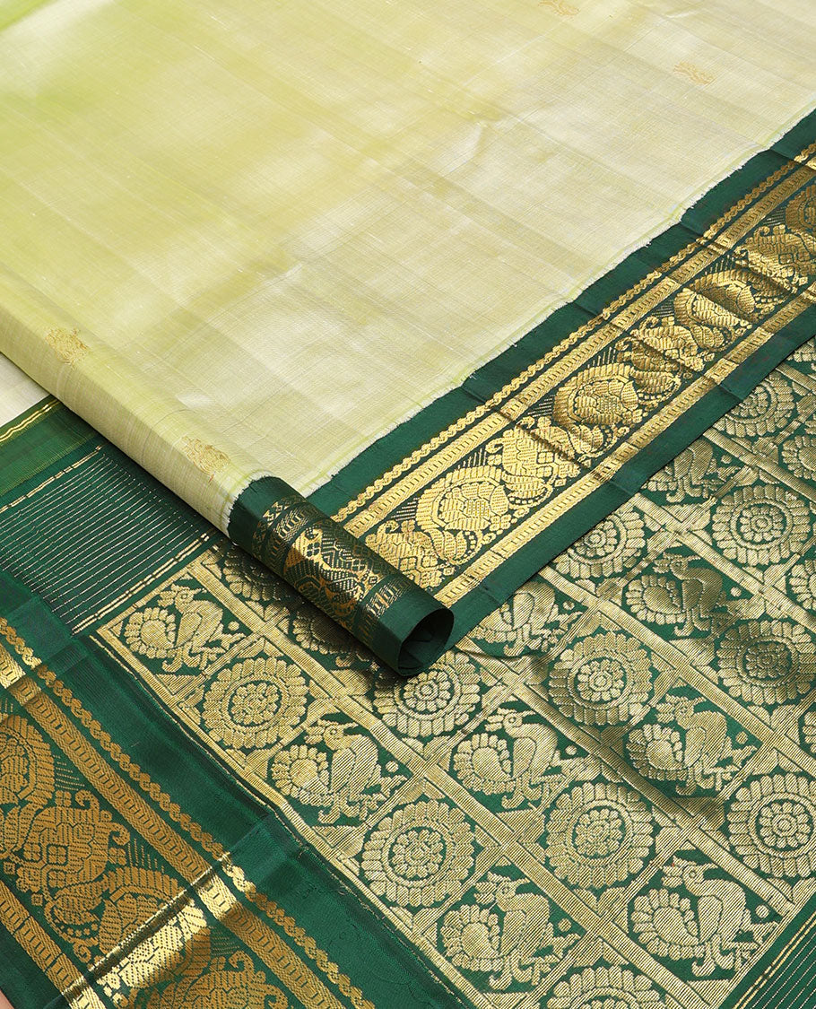 Pastel green buttas Kanchipuram silksaree, contrast one-sided korvai zari design border & annam chakram checked pallu