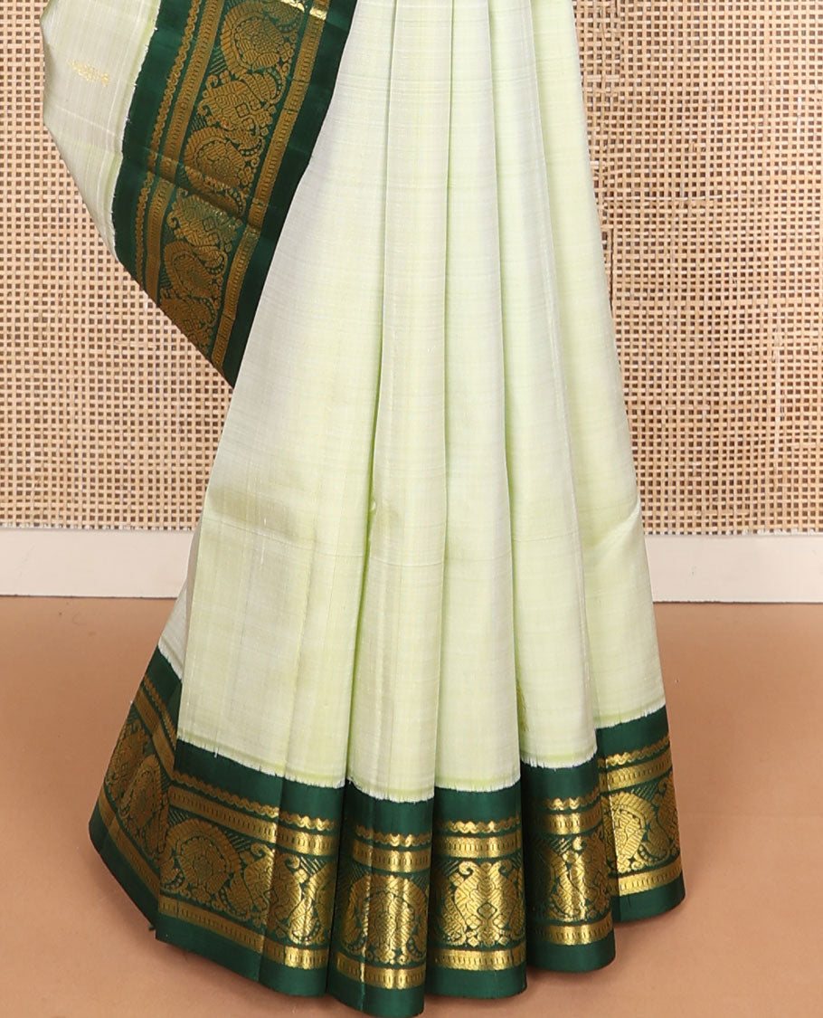 Pastel green buttas Kanchipuram silksaree, contrast one-sided korvai zari design border & annam chakram checked pallu