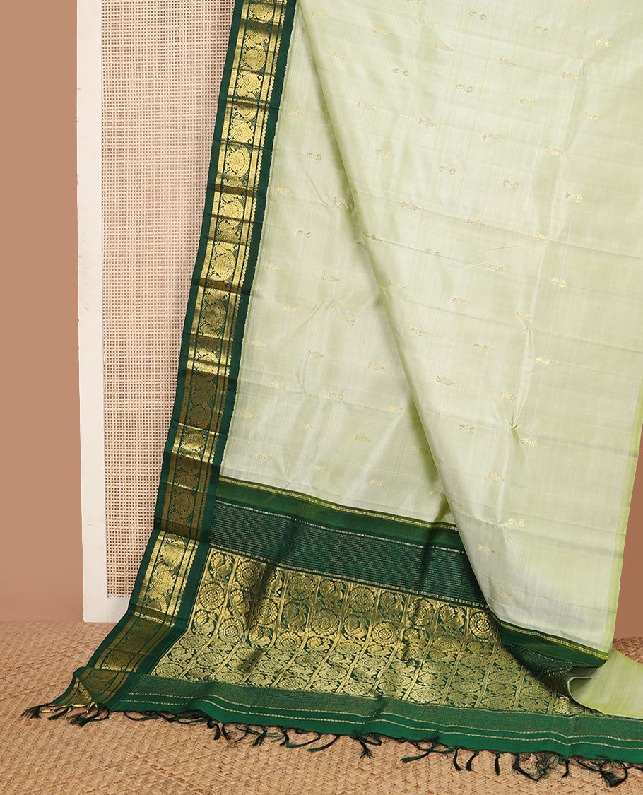 Pastel green buttas Kanchipuram silksaree, contrast one-sided korvai zari design border & annam chakram checked pallu