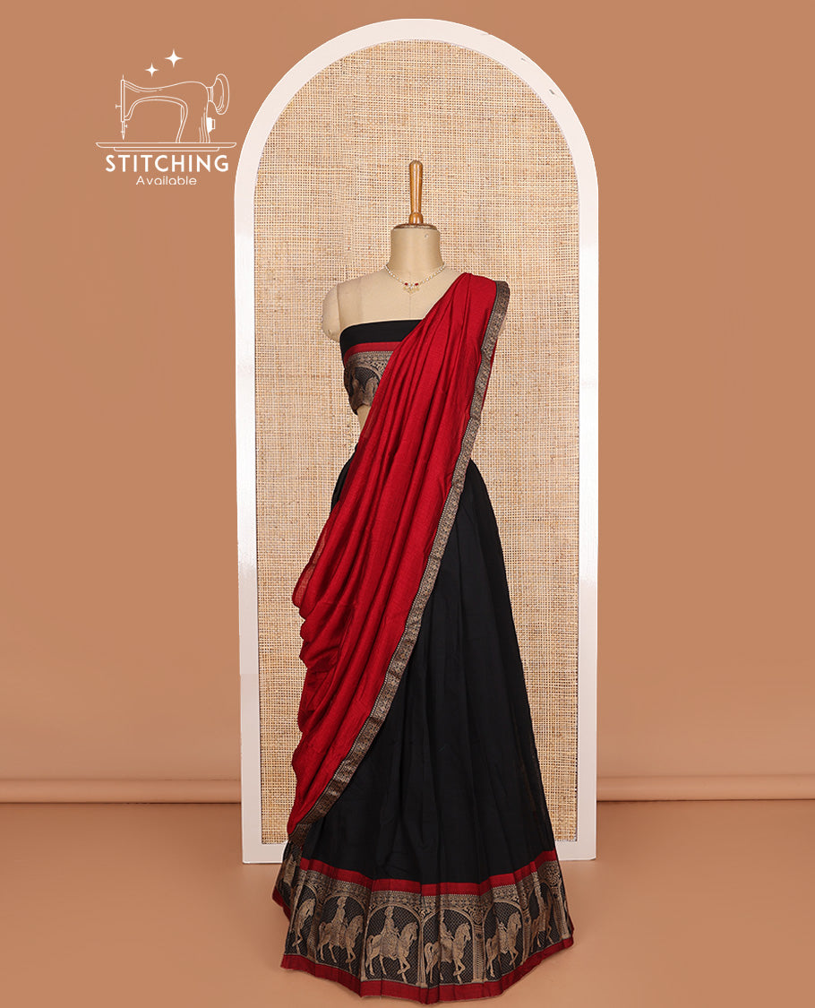 Black cotton half-saree, plain with contrast man on the horse motifs bordered skirt, matching blouse, and contrast dhavani