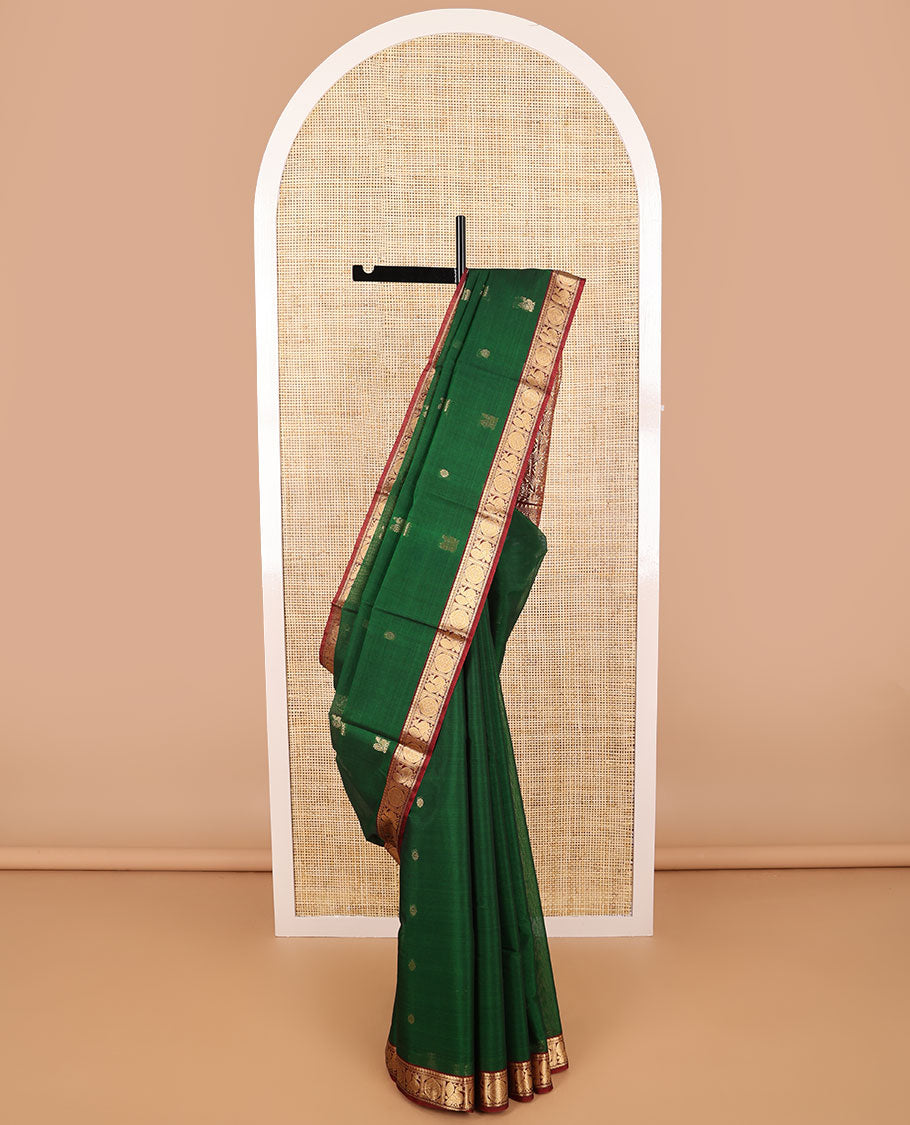 Dark green motifs silk cotton saree with intricate zari design border & floral design pallu