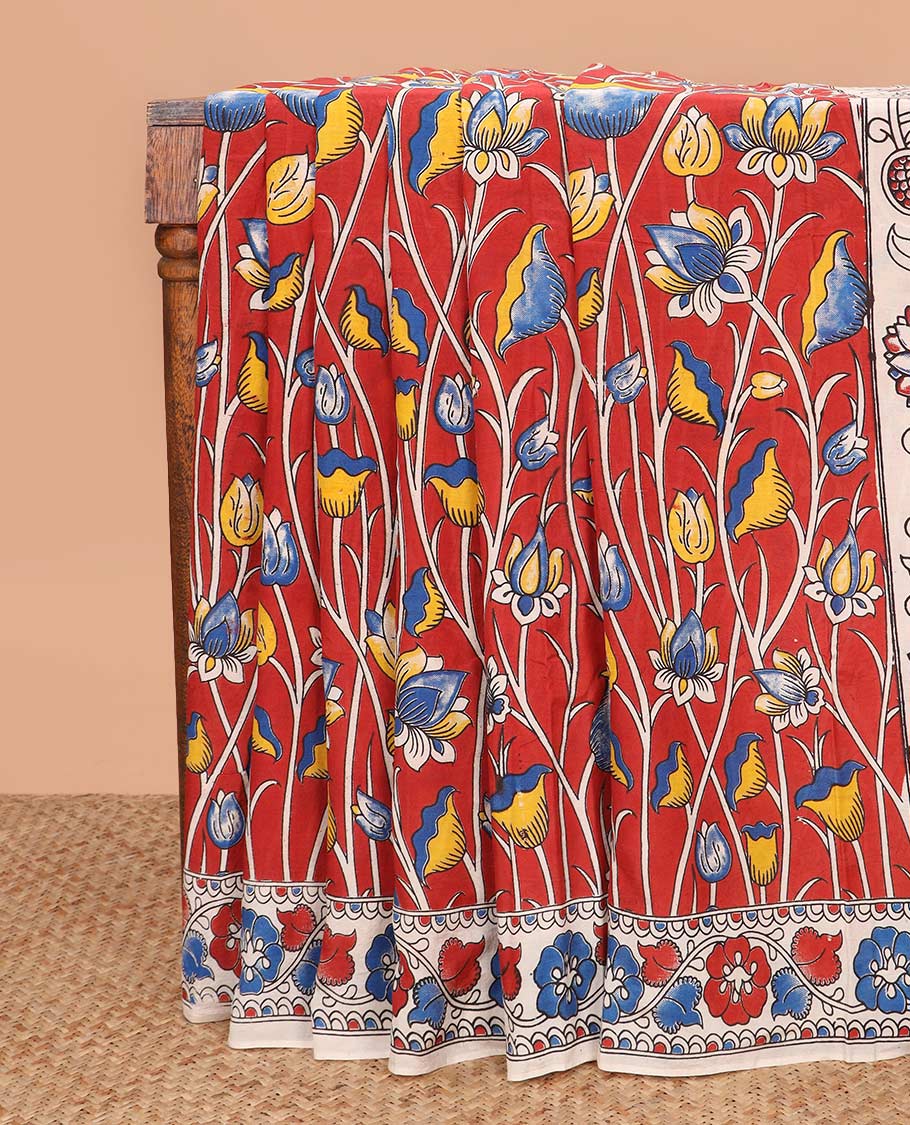 Red lotus floral motifs machine printed kalamkari cotton saree, floral creeper printed border, and peacock printed pallu