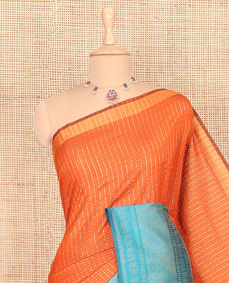 Rust orange zari dot enclosed checked semi-raw silk saree, contrast traditional zari design border, contrast diamond patterned pallu, and a contrast blouse