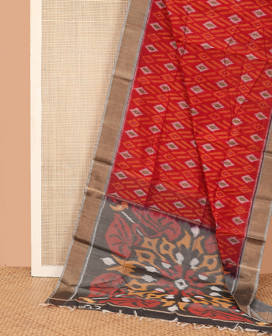 Red buttas and diamond patterned silk cotton saree, contrast bavanji border, and pallu of ikkat floral design