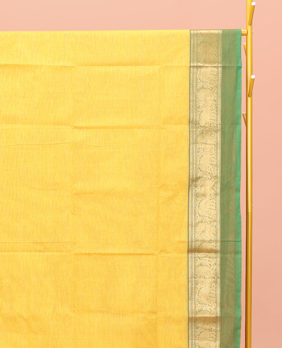 Yellow Chettinad Cotton Saree, Subtly Sparkled with Buttas All Over Its Body, Complemented by a Contrast Ganga-Jamuna Kal Eragina Border of Kodi Peacock and Elephant Designs, Pallu of Buttas and Stripes, and Paired with a Matching Blouse