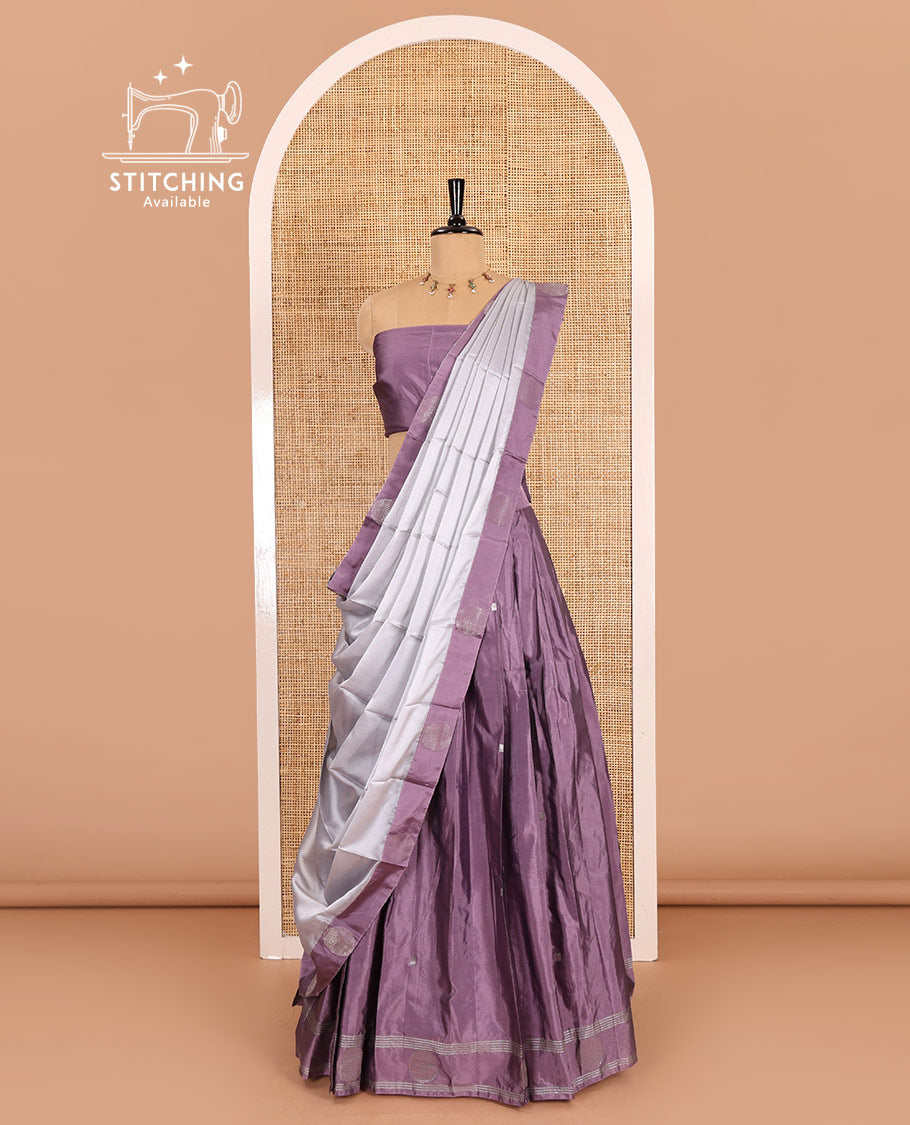 Light voilet half-saree, buttas with self-bordered taffeta silk skirt, a plain blouse, and a contrast round butta bordered satin georgette dhavani