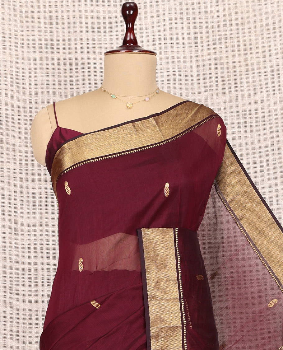 Maroon Maheshwari Cotton Saree, Adorned with Buttas, Highlighted by a Traditional Zari Border, Pallu Gleamed Up with Zari Buttas, and a Matching Blouse