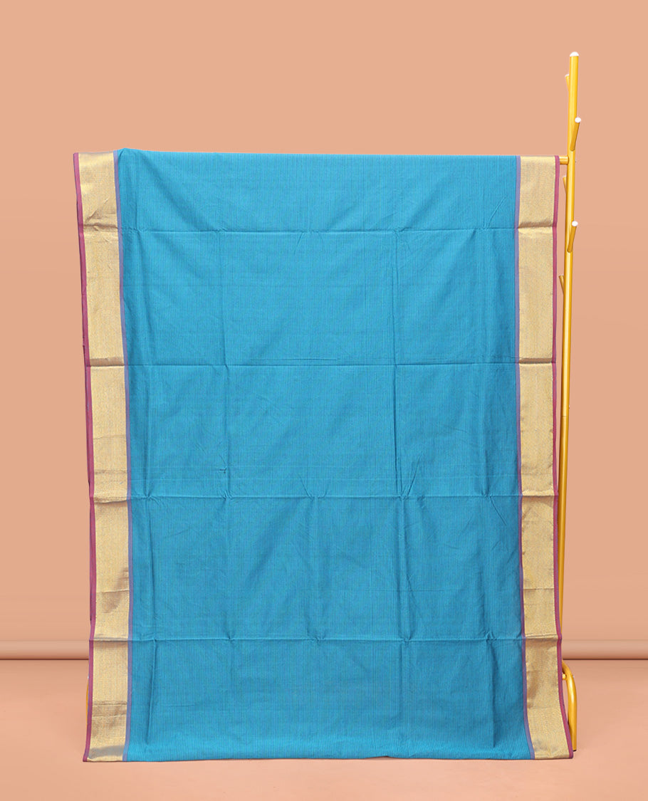 Blue Poly Cotton Saree, Sparsely Threaded with Stripes on Its Body, Complemented by Contrast Peacock-Eyed Border, Striped Pallu, and Paired with a Contrast Blouse