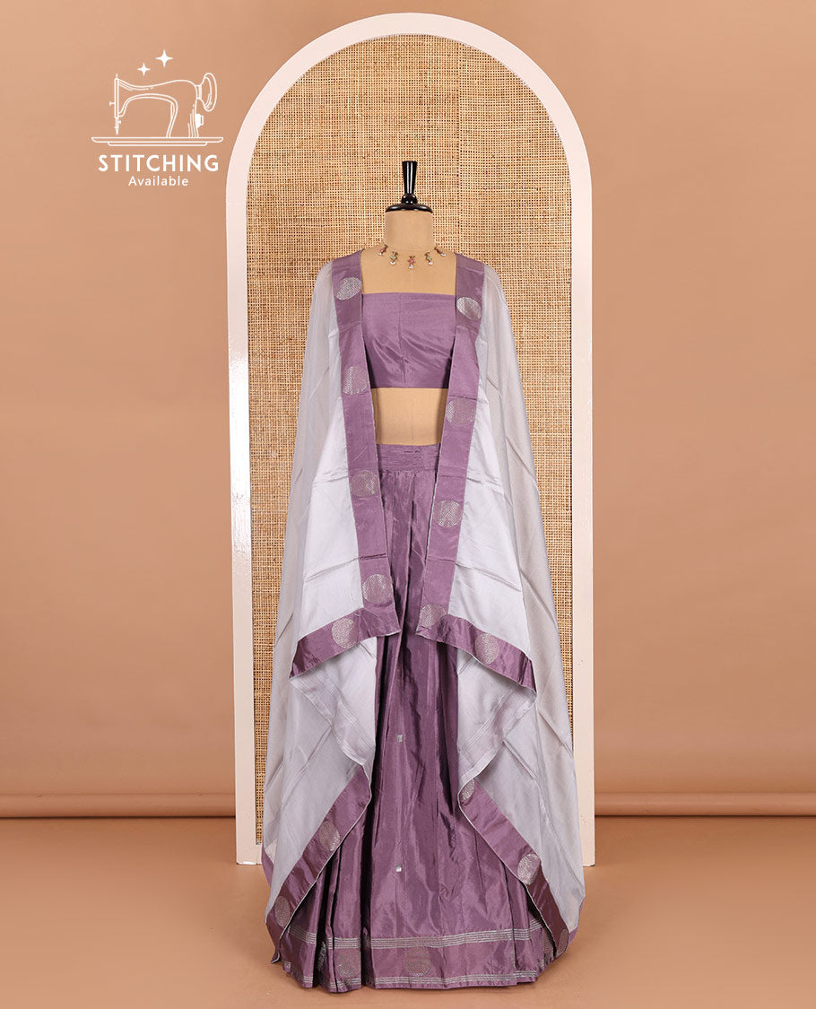 Light voilet half-saree, buttas with self-bordered taffeta silk skirt, a plain blouse, and a contrast round butta bordered satin georgette dhavani