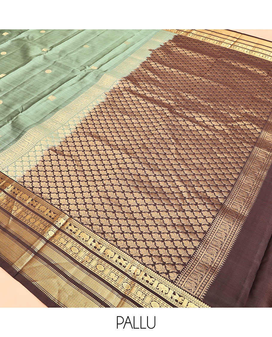 Green Vasundhara Silk Saree, Detailed with Mayil-Chakram Buttas, a Contrast Border of Thikalam, Neli, Kuthirai, Yaanai, Mayil, Chakra, and Mayil Kann, Grand Pallu, and a Contrast Blouse