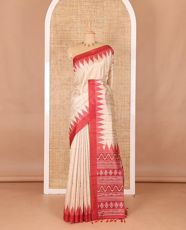 Chikku-red plain Khicha katan silk saree, contrast red temple border, ikkat printed pallu with tassels, and a contrast blouse