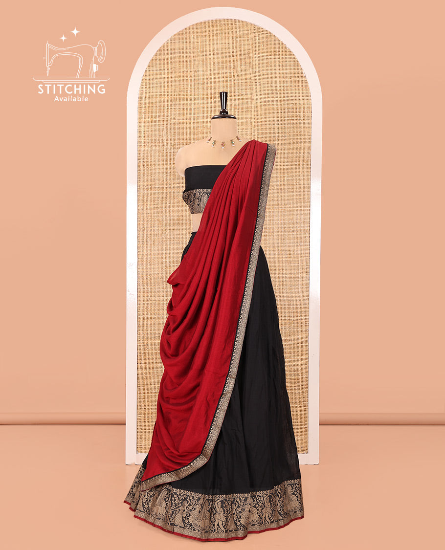Black Mercerised Cotton Half-Saree Set, Plain with Dancing Figurines Woven Bordered Skirt, Paired With a Matching Blouse, and Comes with a Contrast Dhavani