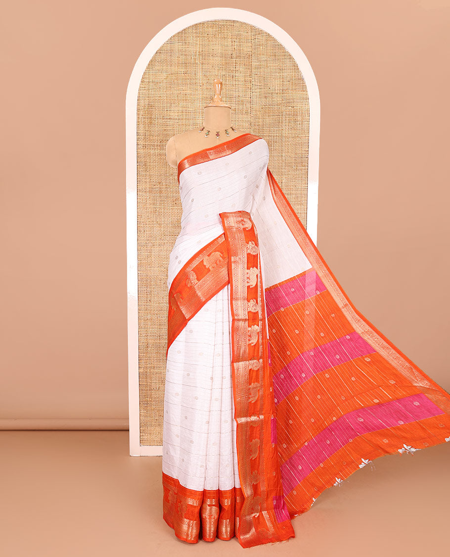 White zari buttas and striped dola silk saree, contrast traditional zari border of elephant and peacock buttas, zari design pallu, and a contrast floral print with zari work blouse
