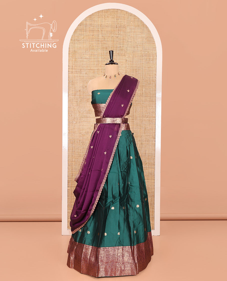 Green and Purple Semi-Banarasi Half-Saree, Adorned with Zari Buttas on Its Skirt, Complemented by a Contrast Traditional Zari Designs Woven Border, Paired with a Matching Blouse, and a Satin Georgette Embroidered Scallop Dhavani