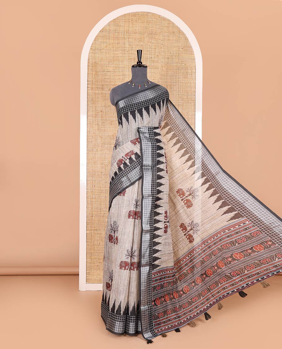 Chikku elephant motifs printed linen cotton saree, contrast temple printed checked border, ikkat style floral printed pallu, and a contrast floral printed blouse